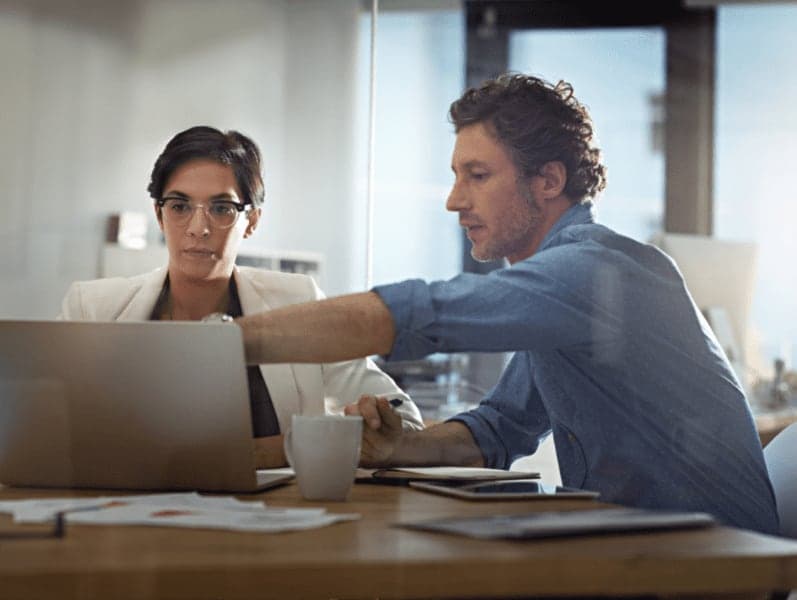 Shot of business people working on a laptop in an office