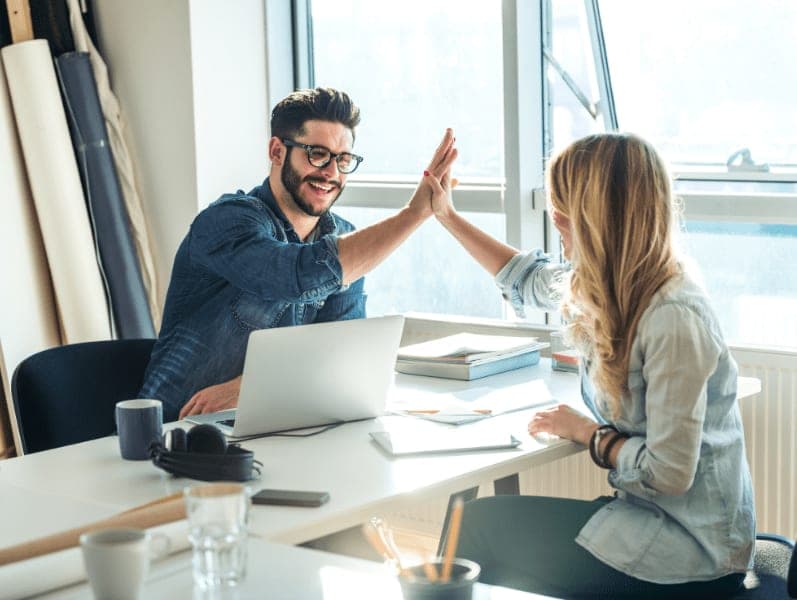 Man giving high five to his female colleague