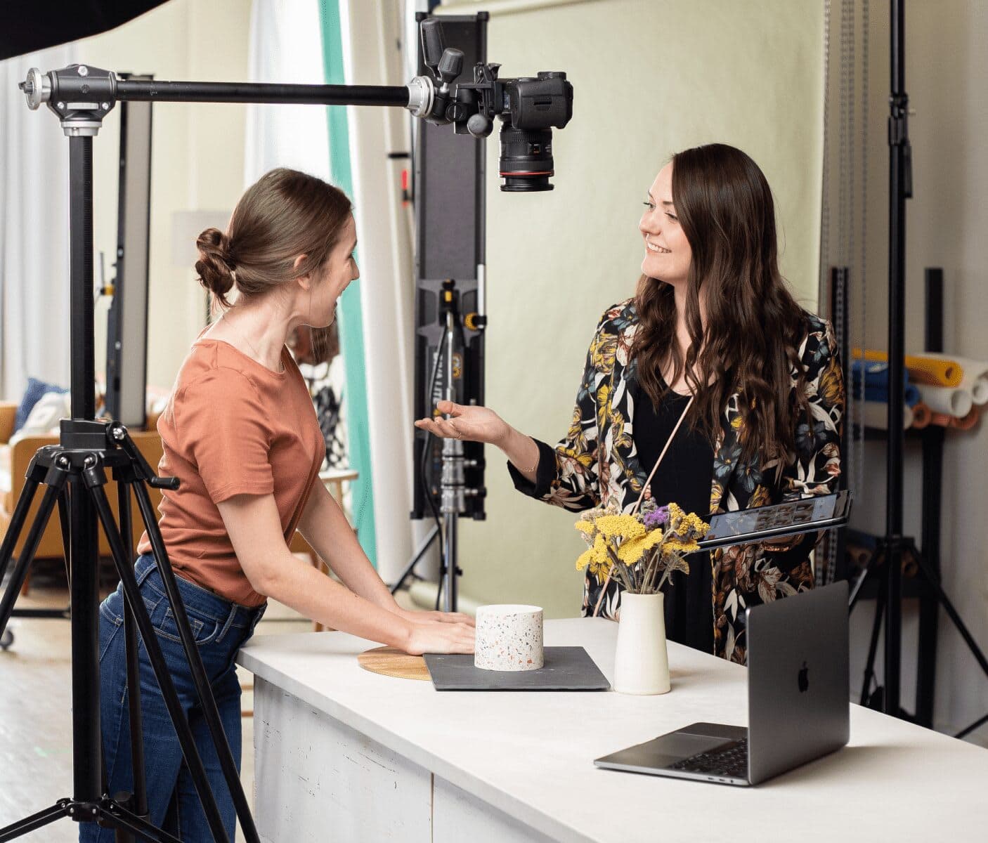 two women talking at a desk