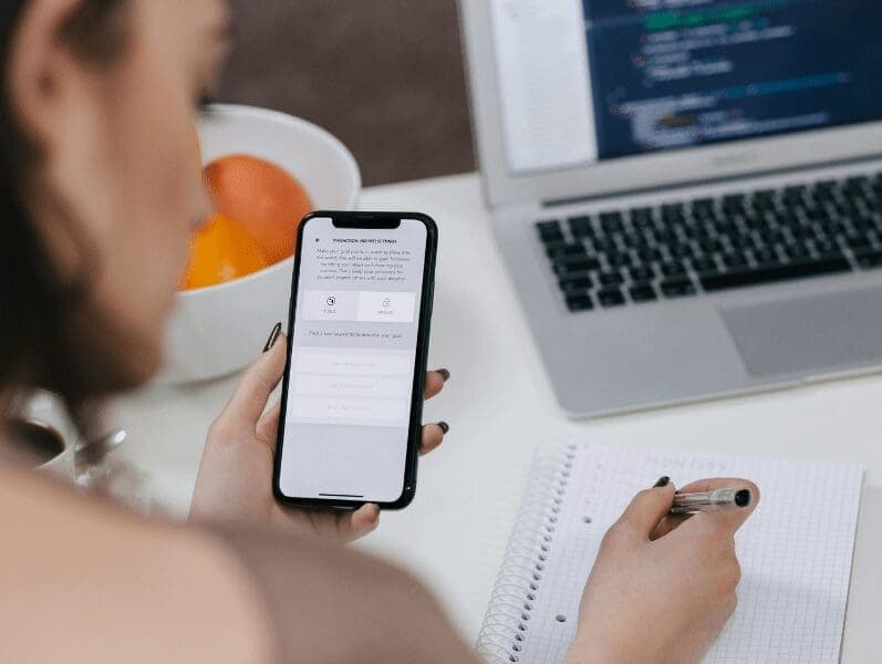 Right side view of a womans face and her holding her phone to login securely