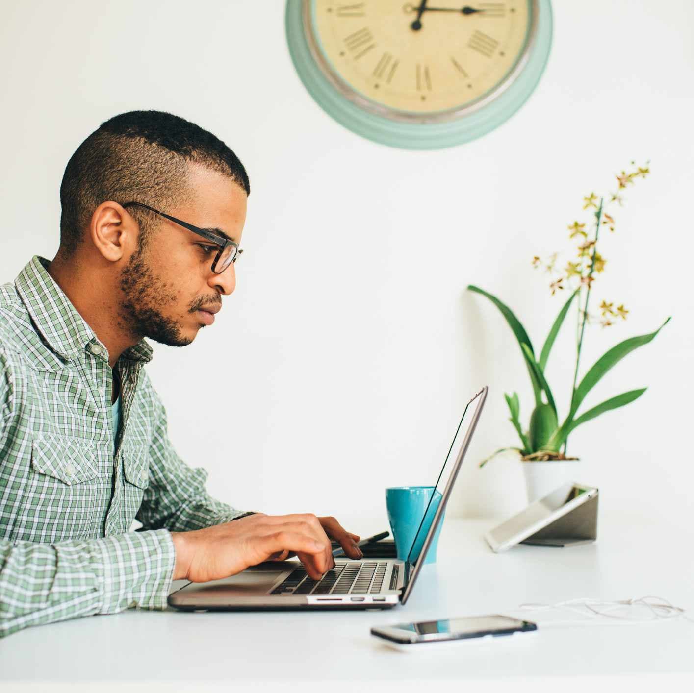 Young professional man using laptop