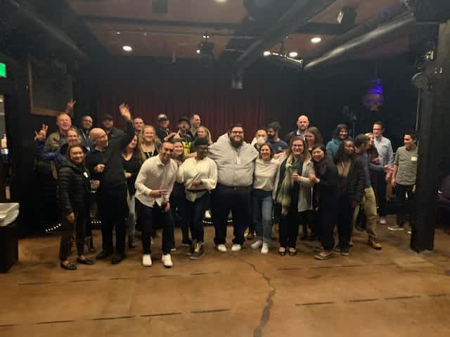 A group of people poses together at GPAC.