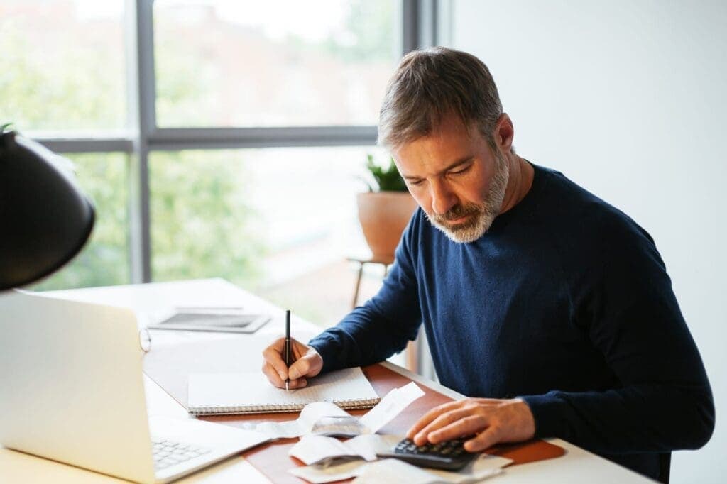 Male remote accountant working on a client's taxes.