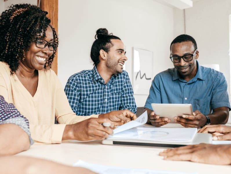 Team of people siting around table talking about dream careers