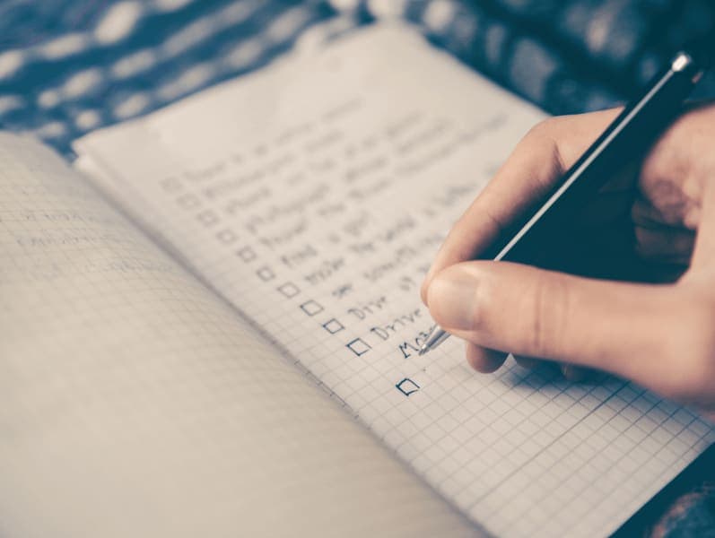 Not book with woman writing out her last years reflection goals