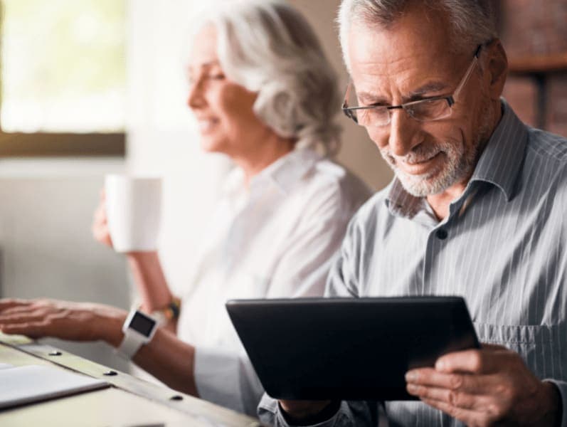 Older couple reviewing documents on an ipad